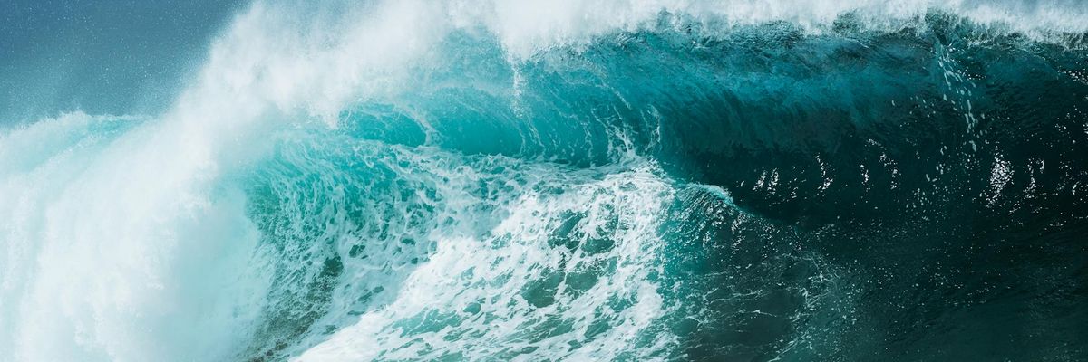 Wide landscape showing abstract waves of blue light representing energy